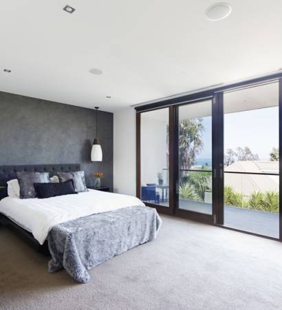 Spacious interior of designer master bedroom in luxury contemporary Australian home