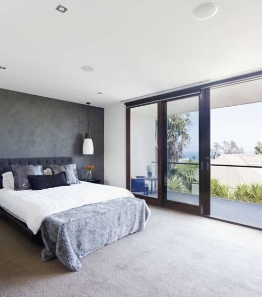 Spacious interior of designer master bedroom in luxury contemporary Australian home