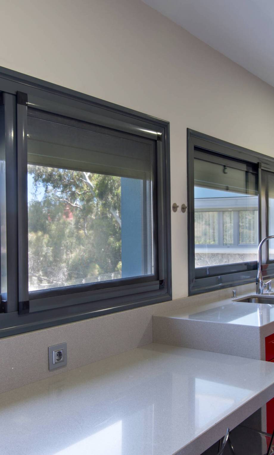 modern kitchen in red, with exterior view. Interior design of house.