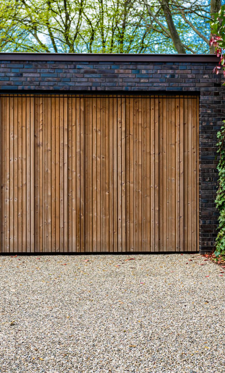 wide garage door and concrete driveway in front